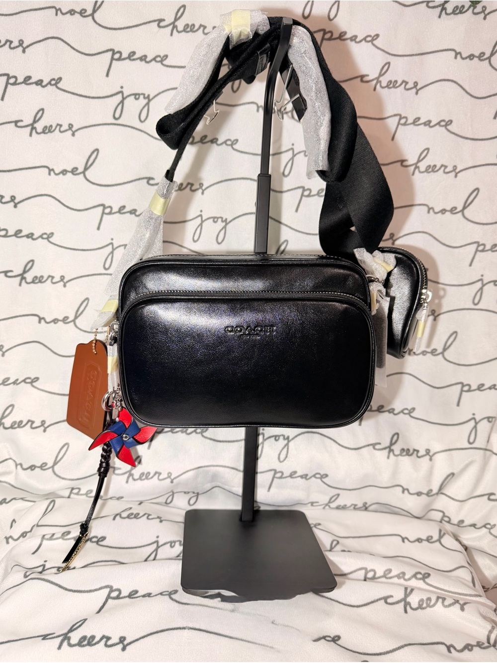 Coach Finlay Crossbody Bag
With Charms. Smooth black leather NWT